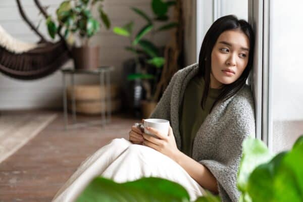 Sick woman sad, alone at home