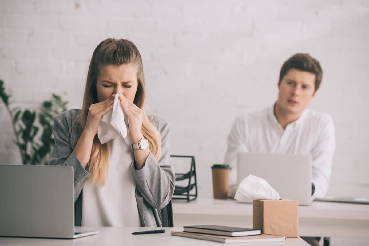 Worker annoyed by sick coworker at the office