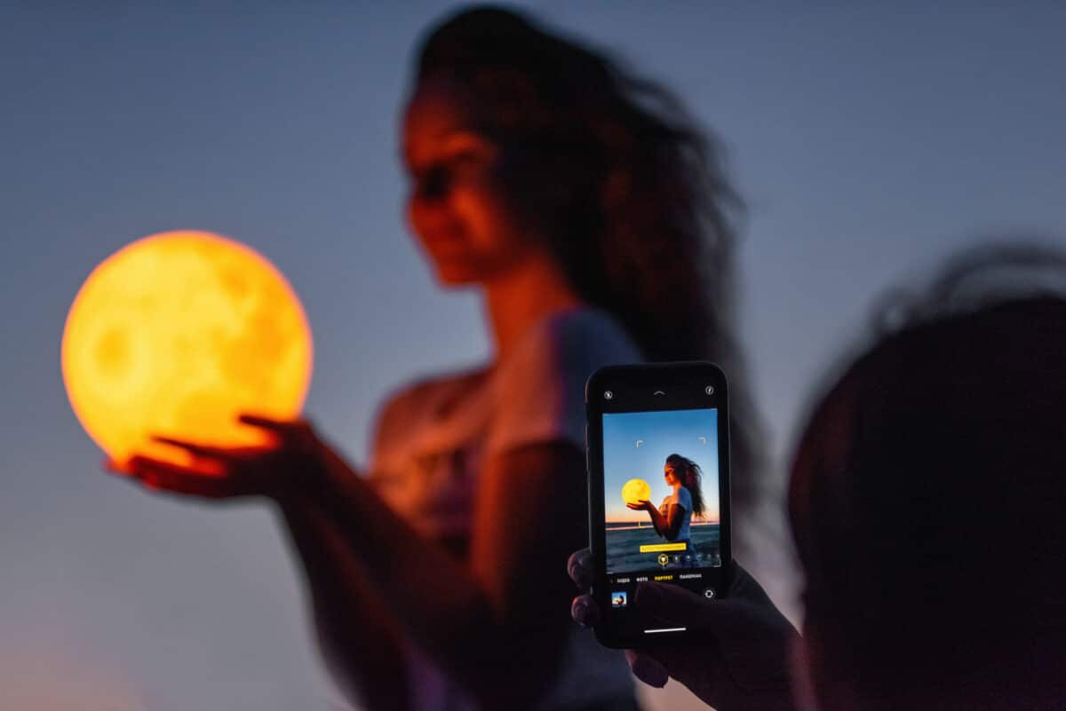 Smartphone photo of woman holding the Moon