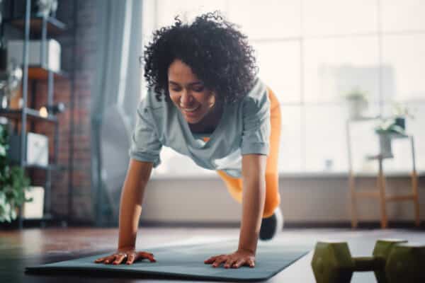 Woman working out doing yoga and core exercises