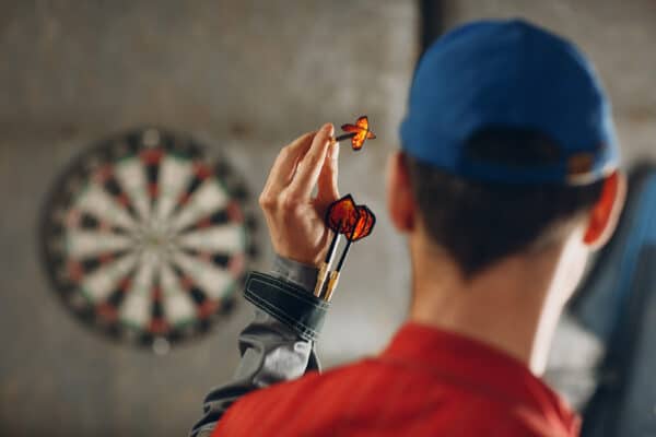 A man plays a game of darts