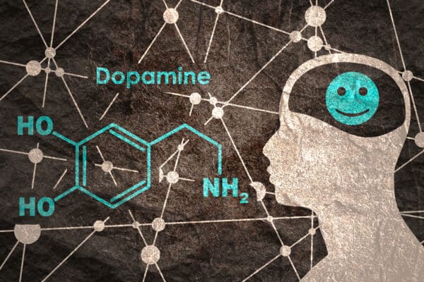 Dopamine formula next to a happy brain