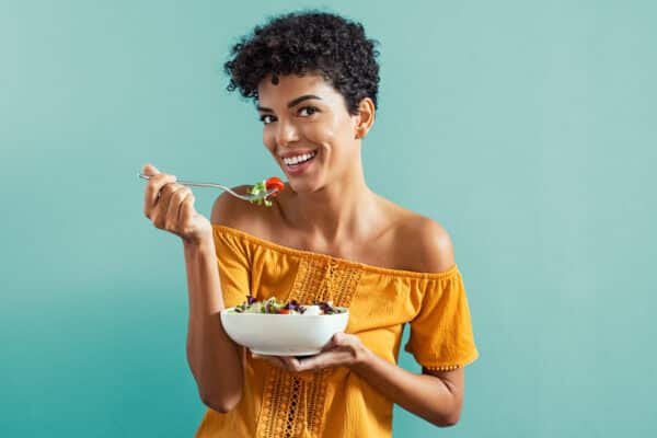 Woman eating healthy, plant-based salad