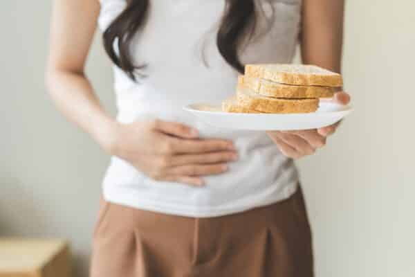 Woman with stomach pain from gluten allergy or sensitivity