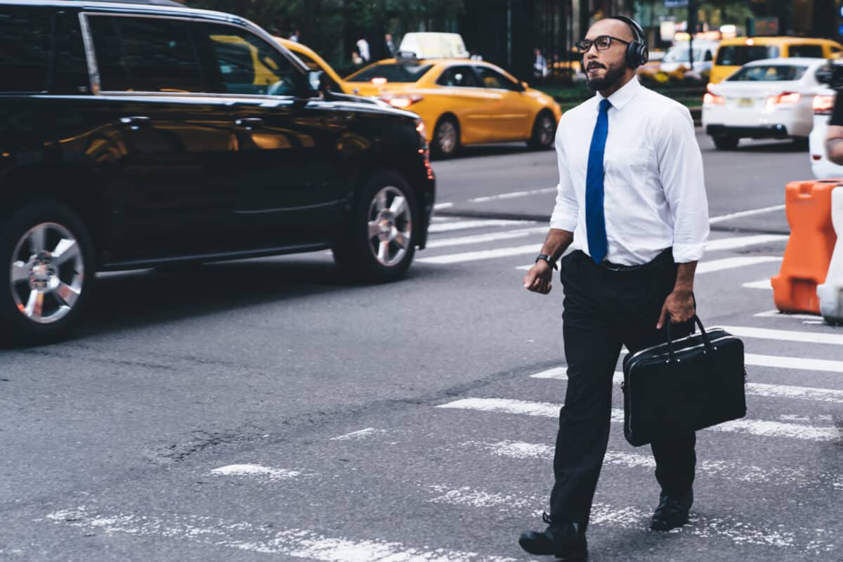 Businessman crossing at crosswalk in busy New York City