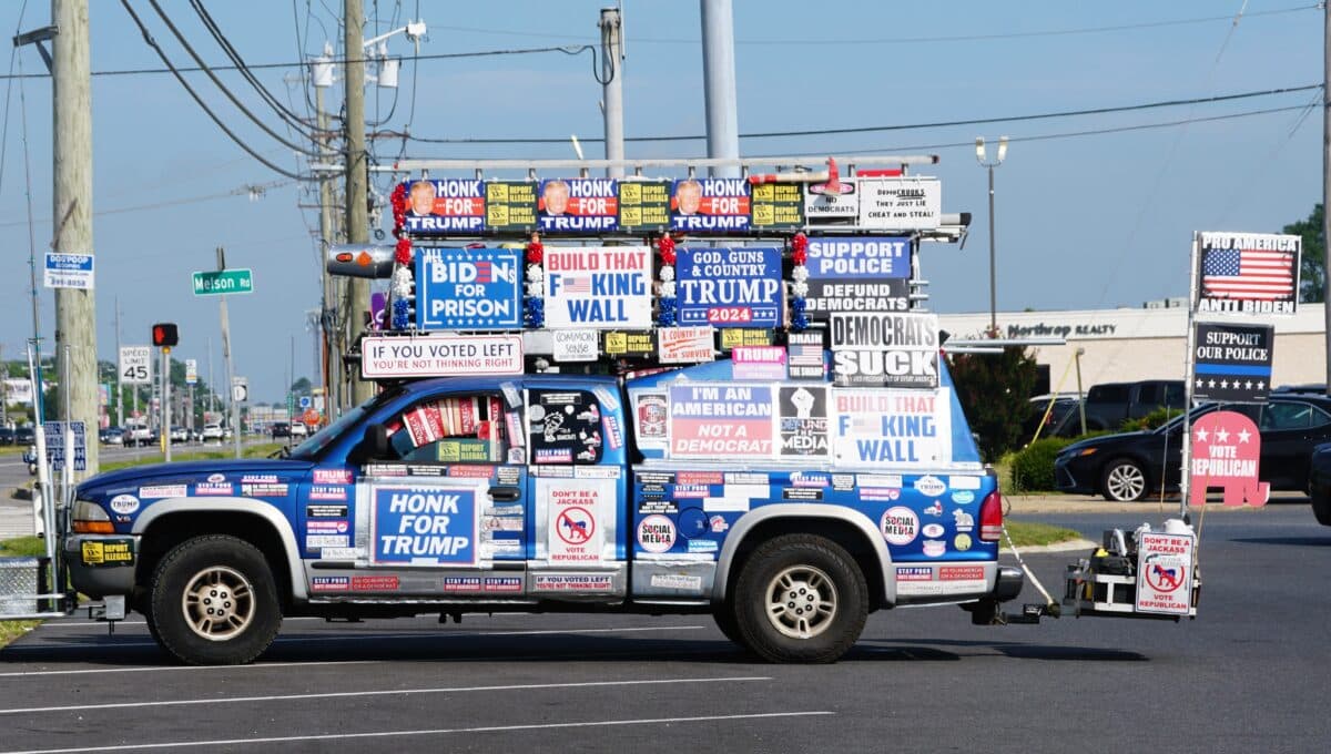A pickup truck covered with political stickers supporting Donald Trump and Republican party.