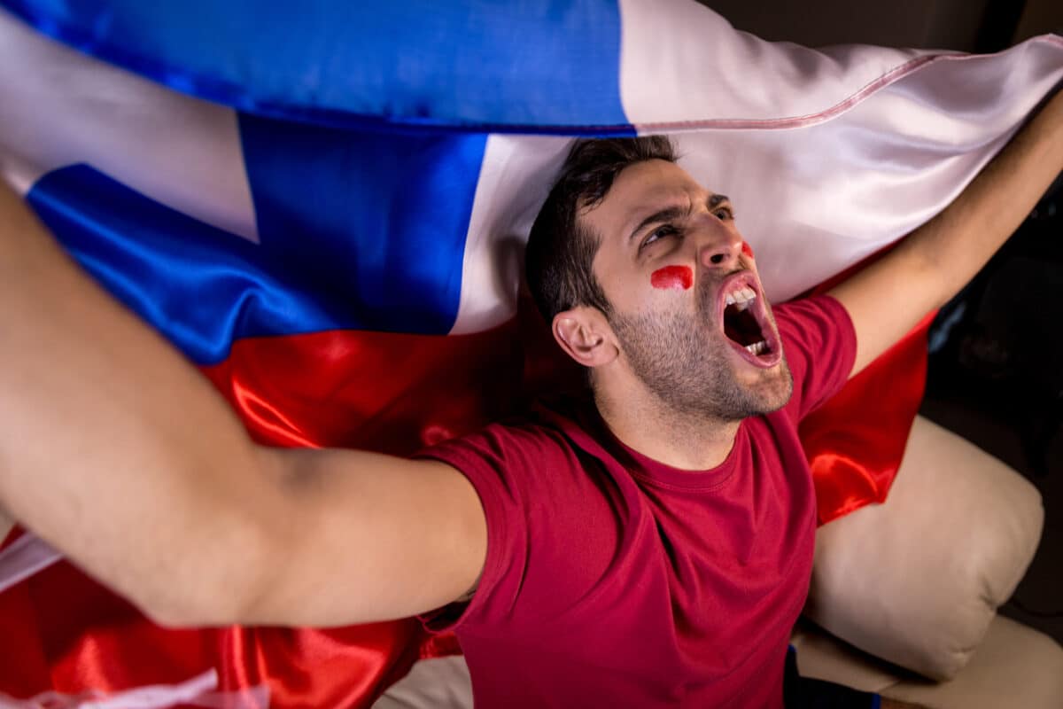 Chilean soccer fan celebrating while watching game