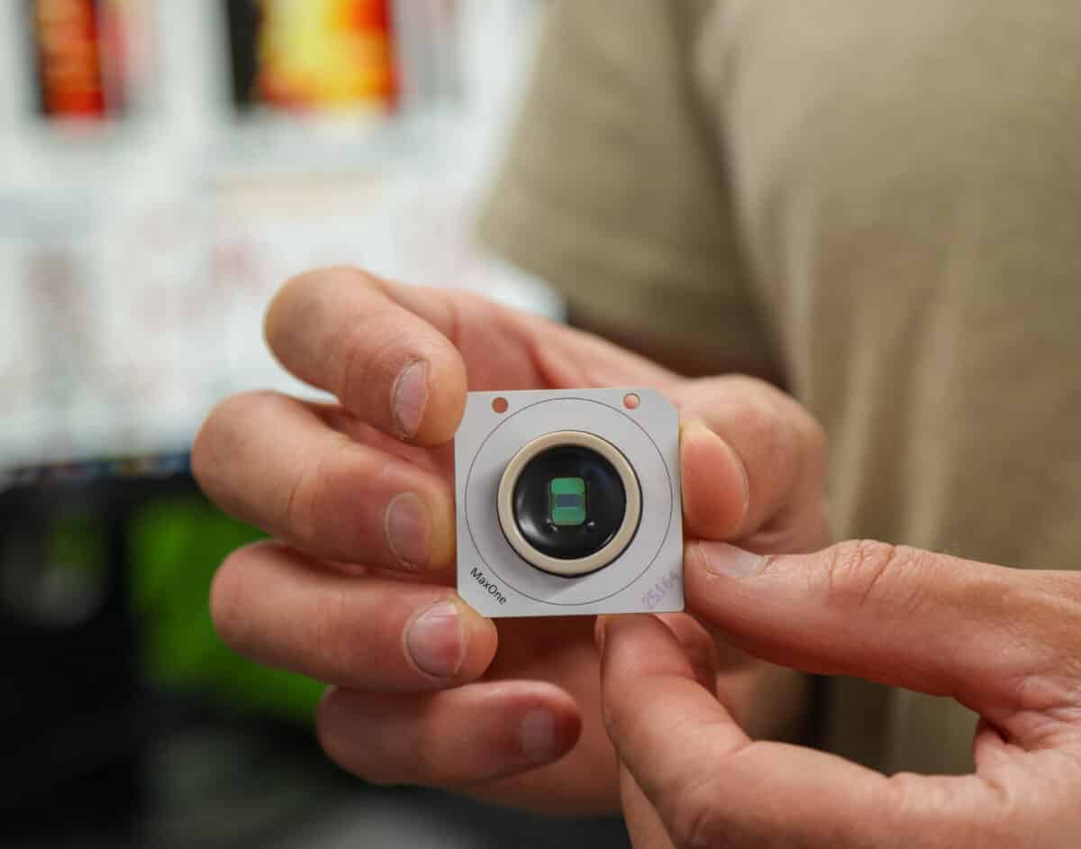 Tal Sharf holds a CMOS-based microelectrode array chip used to precisely locate the electrical activity of single neurons within millimeter-sized organoid tissue.