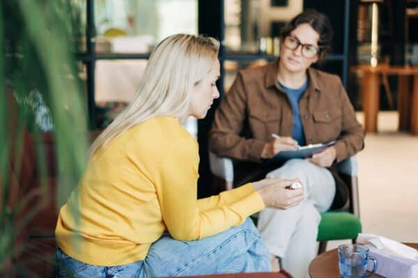 A therapist has a session with a female patient