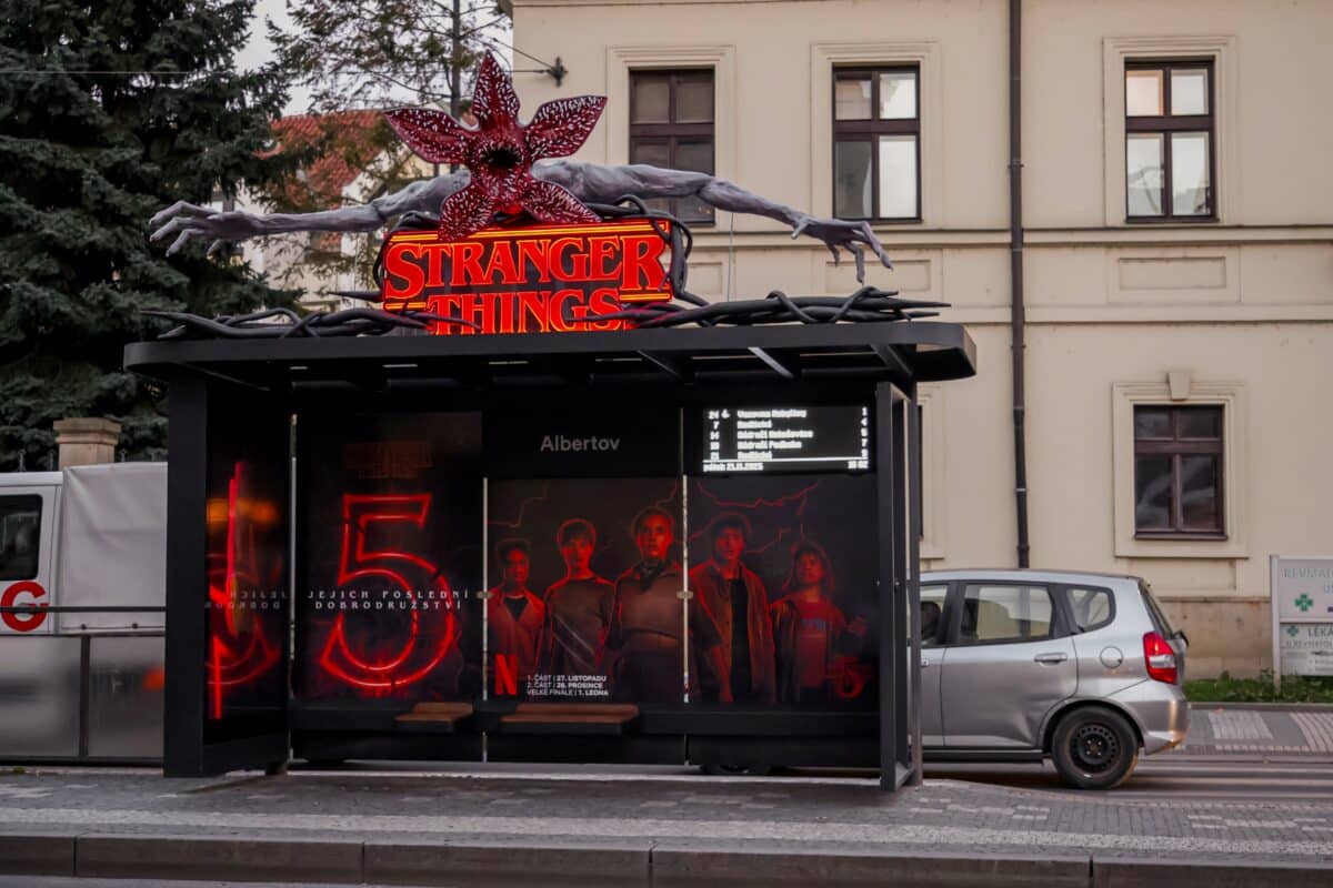 A tram stop in Prague decorated in a Stranger Things theme to promote the upcoming fifth season, featuring a large Demogorgon installation on the roof.