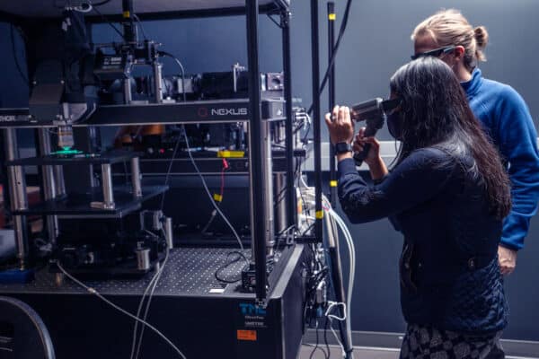 Scientists at the Allen Institute use sophisticated microscopes to image the new iGluSnFR indicators, to study how neurons perform computations in the living brain. Here two scientists are aligning one of their microscopes.