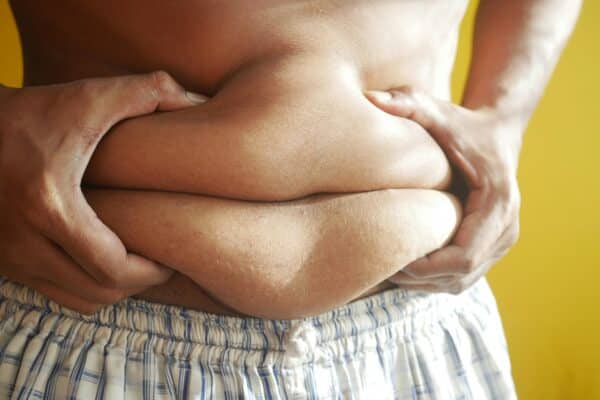 Man holding the visceral fat of his beer belly