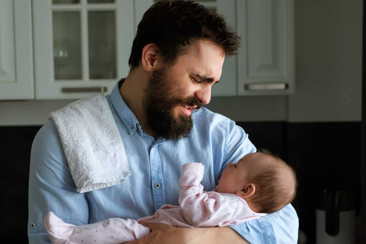 Frustrated and stressed dad can't calm his crying baby