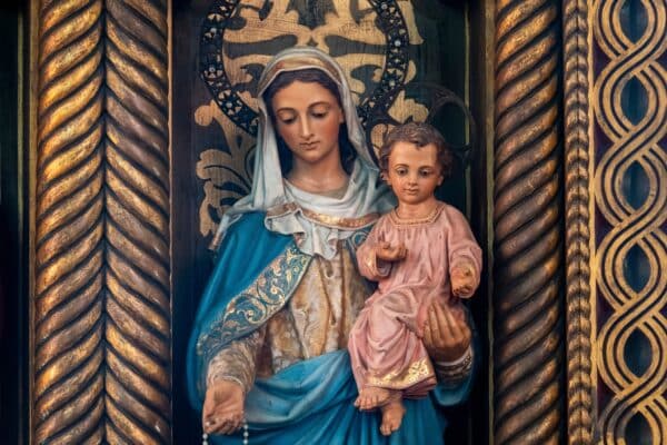 Statue (19th century) of Blessed Virgin Mary holding baby Jesus Christ in her arms.