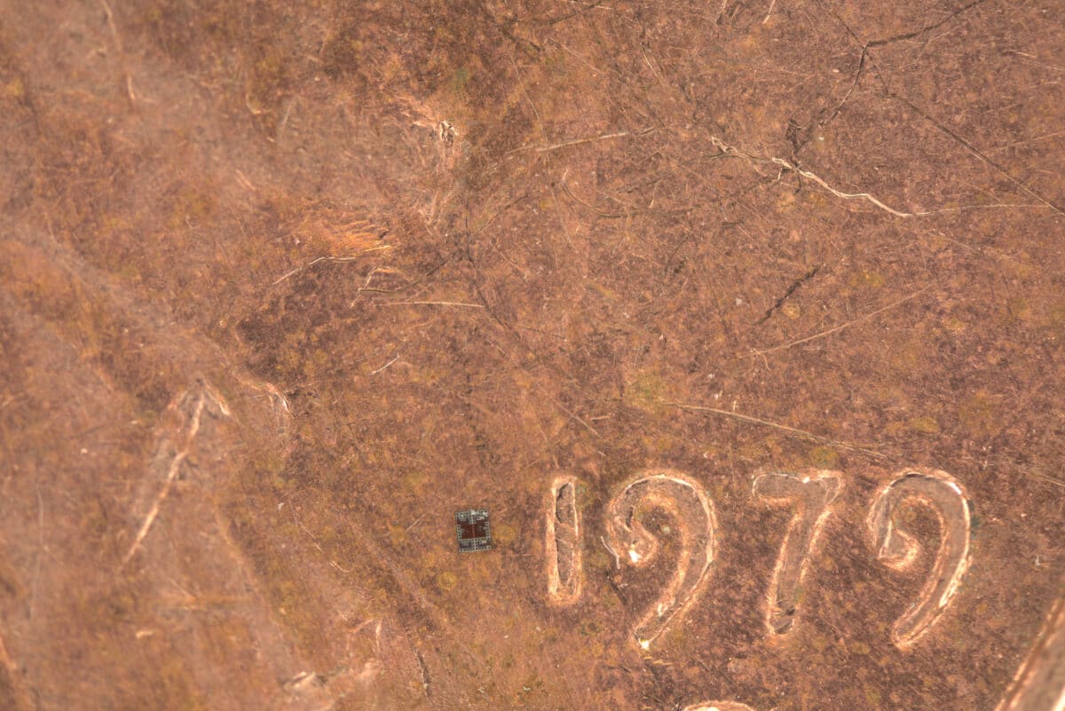 The robot is a tiny rectangle, just slightly wider than the 1 in 1979 on the penny, and about a third as tall.