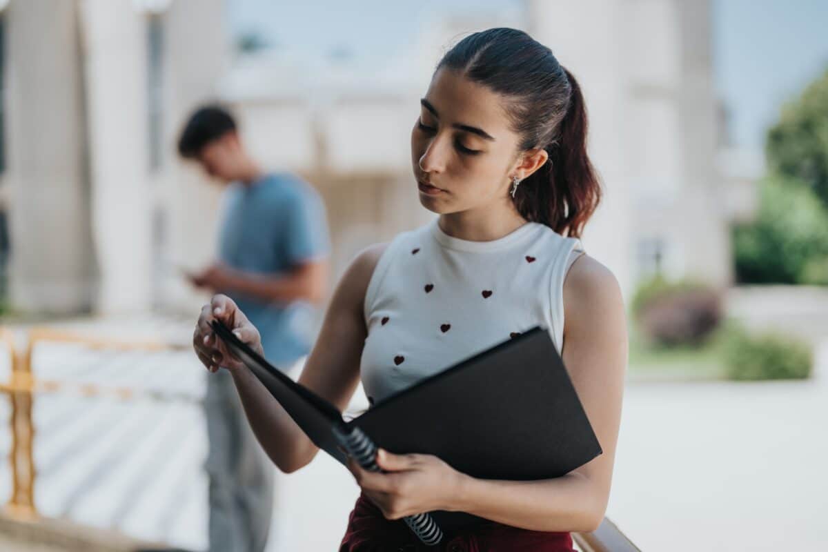 student with notebook