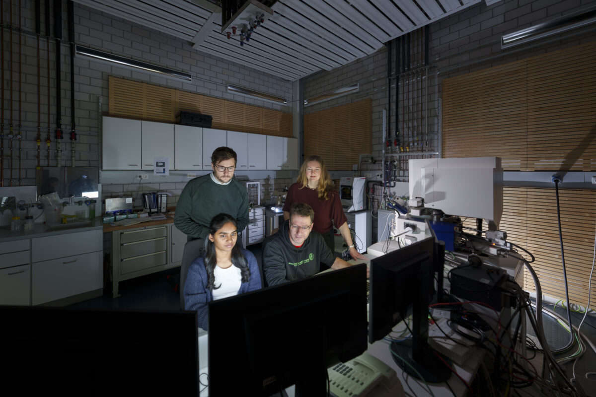 Photograph of four of the paper’s authors observing scanning electron microscopy (SEM) of elephant whisker specimens. Image includes Deepti S. Philip (front left), Dr. Andrew K. Schulz (back left), Prof. Gunther Richter (front right), and Prof. Katherine J. Kuchenbecker (back right). 