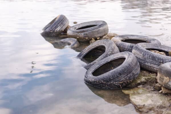 Old rubber car tires polluting waterways