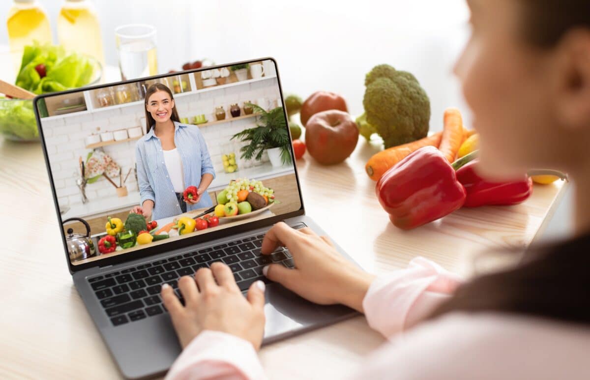 Young,Woman,Using,Laptop,Computer,To,Take,Part,In,Online