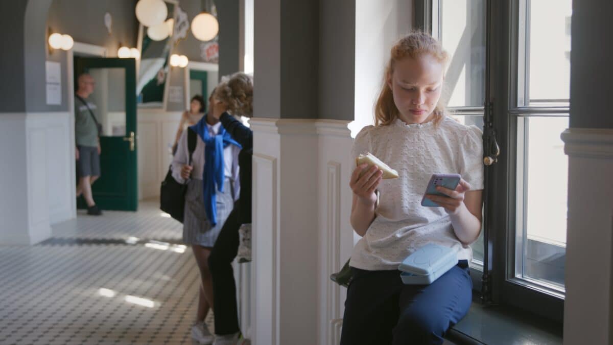 Teenage,Girl,Having,Lunch,And,Surfing,Internet,On,Smartphone,Sitting