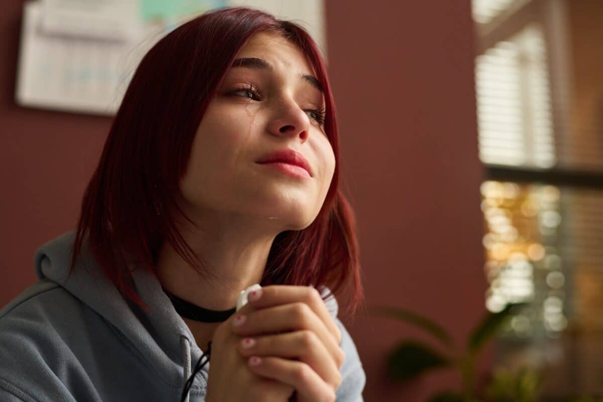 Crying,Teenage,Girl,With,Tissue,In,Hands,Sitting,In,Front
