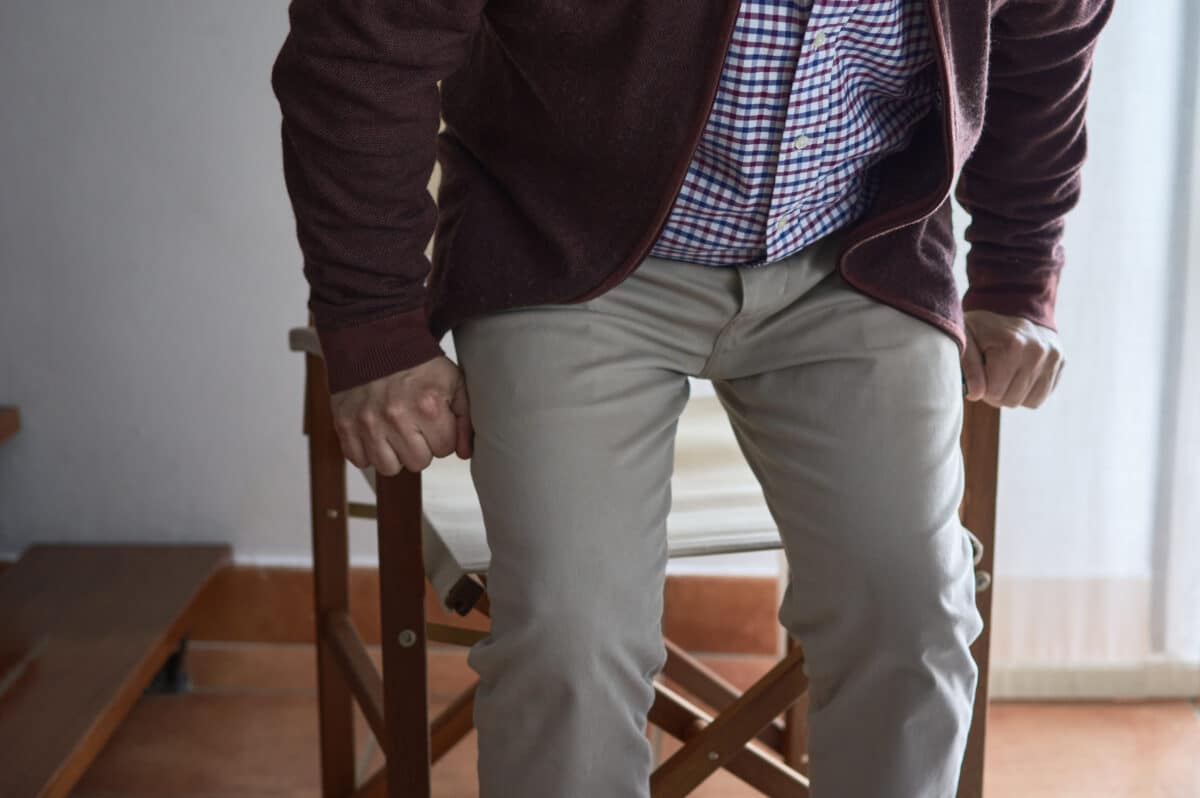 Older man rising from chair