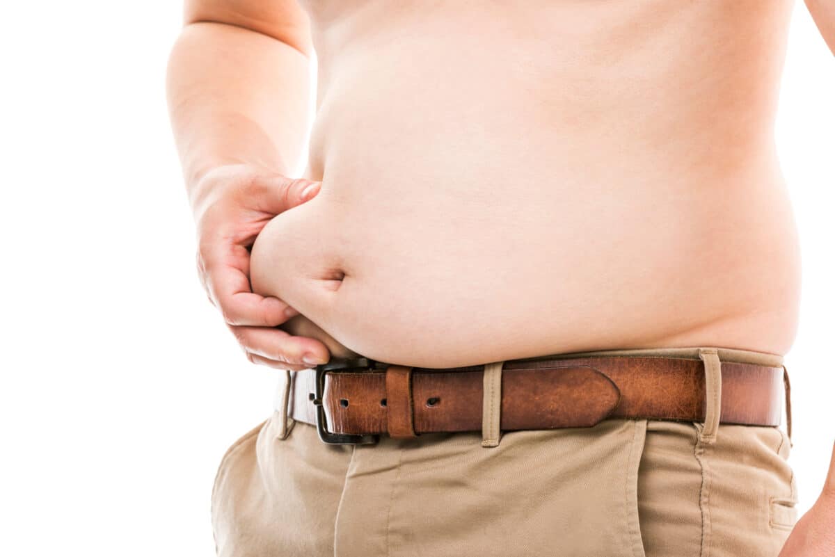 Man holding his belly fat (visceral)