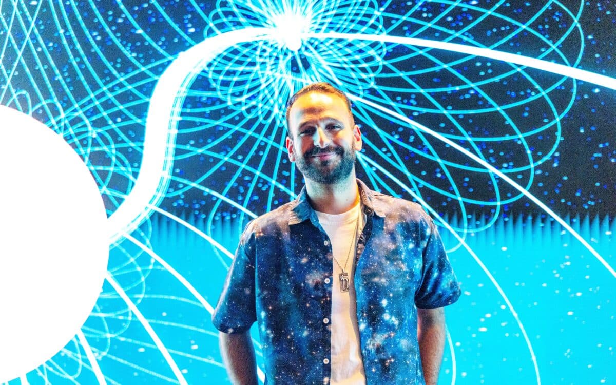 Lead author Kovi Rose from the University of Sydney in front of illustration of the white dwarf binary.