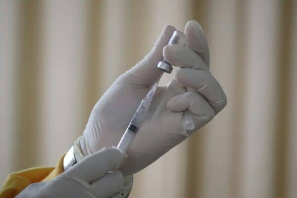 Close-up view of a syringe and vaccine vial