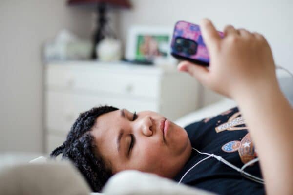 Teen using smartphone in bed