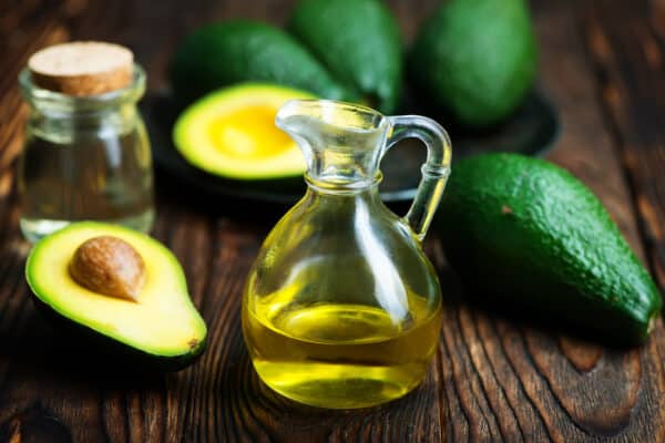 pic of avocado oil in bottle and on a