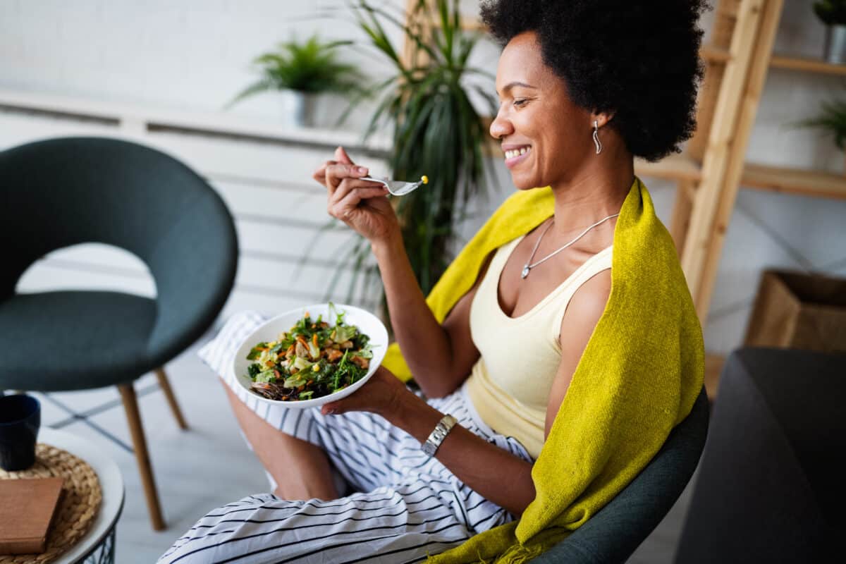 Woman eating salad as part of a healthy diet