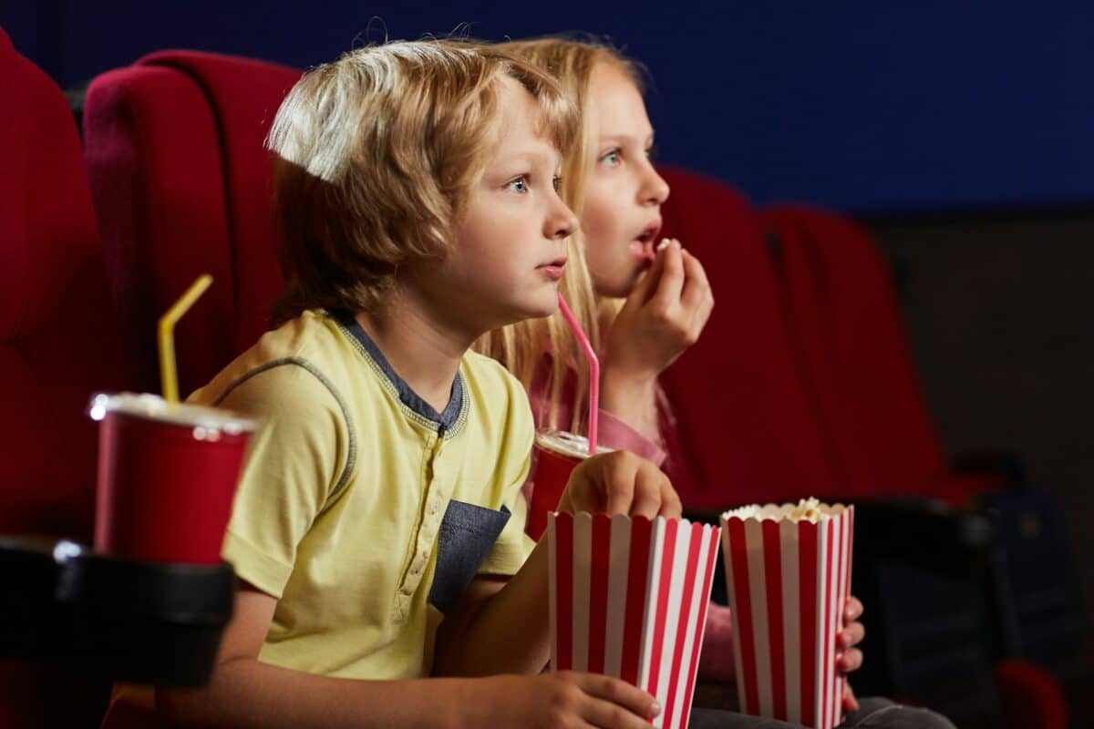 Children excitedly watching a movie