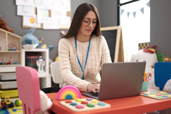 A teacher uses her laptop computer in the classroom