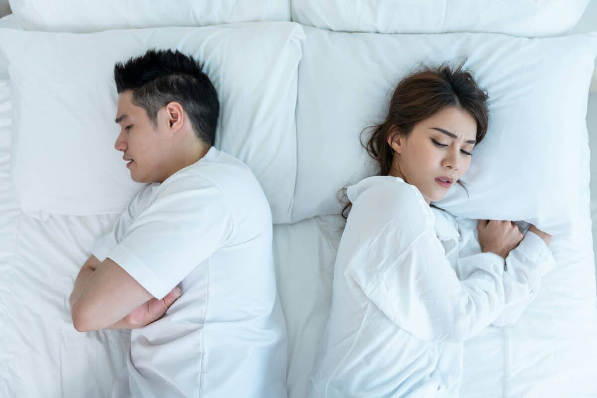 couple in bed annoyed