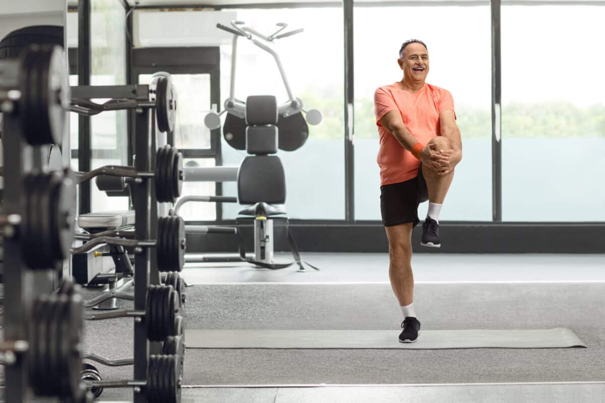 Older man balancing at gym