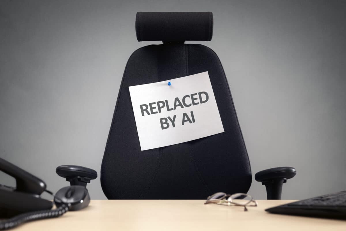 Empty office chair with ‘Replaced by AI’ sign on it