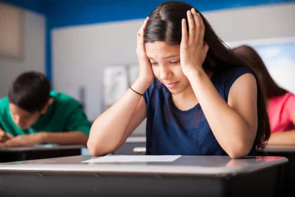 Teen girl stressed out during test in class