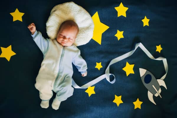 A cute costume showing a sleeping baby in space