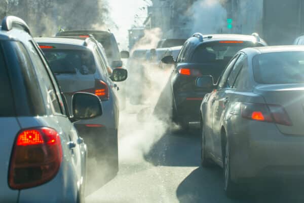 pollution from the exhaust of cars in the city in the winter. Smoke from cars on a cold winter day