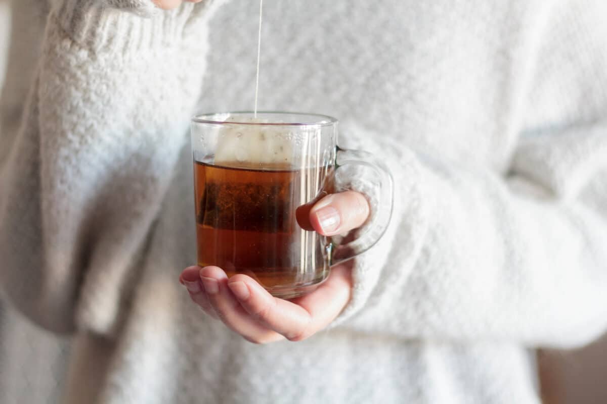 Woman steeping tea bag