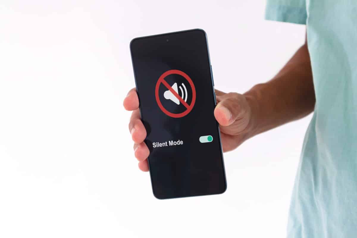 Man holds a smartphone in silent mode
