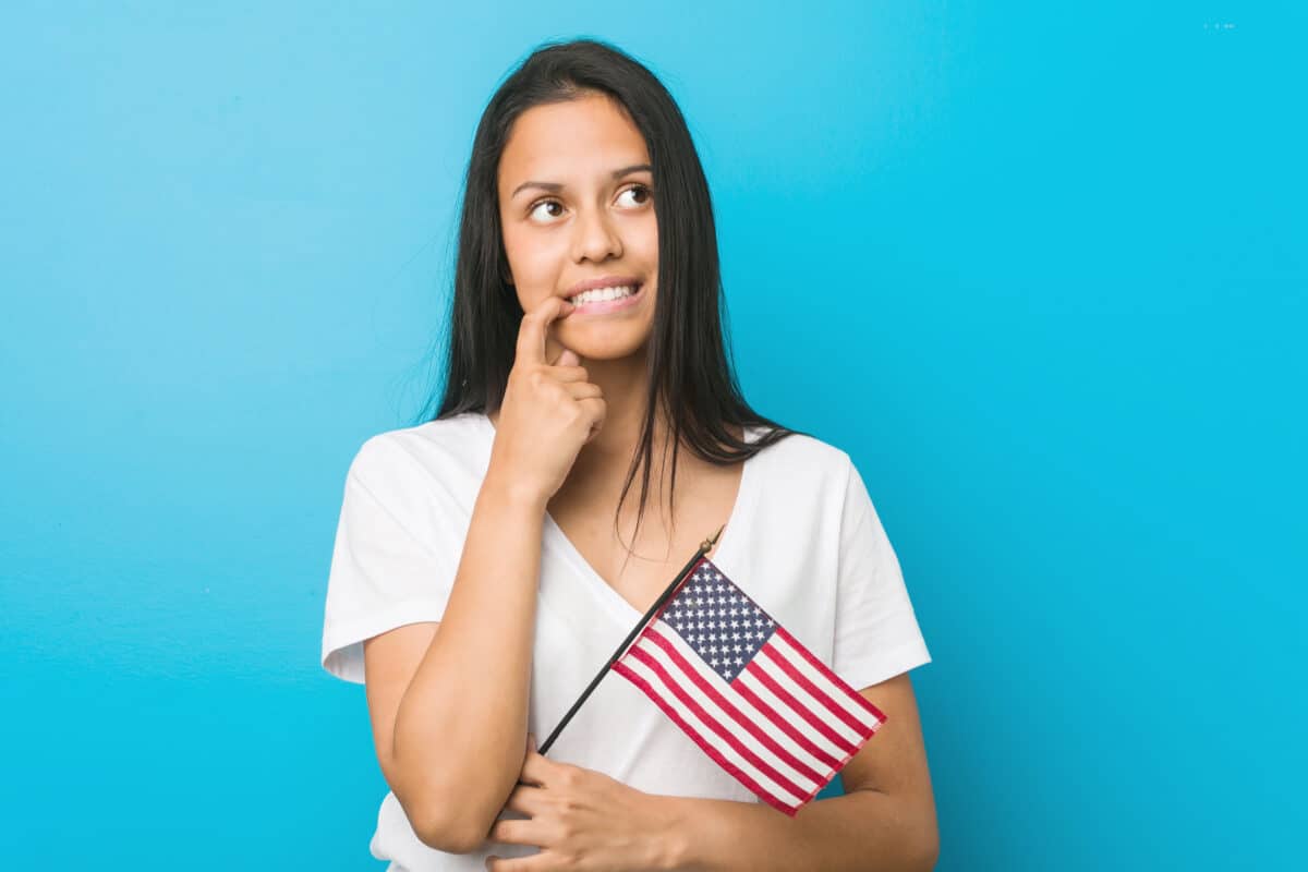 Woman with American flag thinking