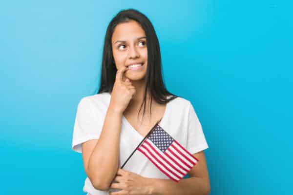 Woman with American flag thinking or unsure