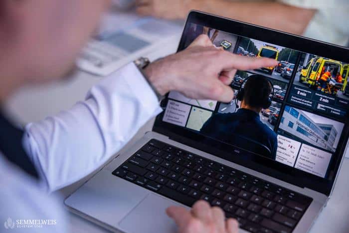 pic of researcher showing weather data and emergency services on the road on a laptop screen