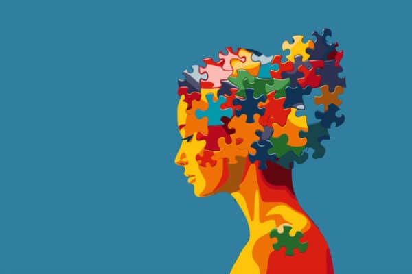 woman with a puzzle brain. Concept for neurodiversity, Disability Pride Month, world brain day, mental health and brain neurological health, autism spectrum disorder