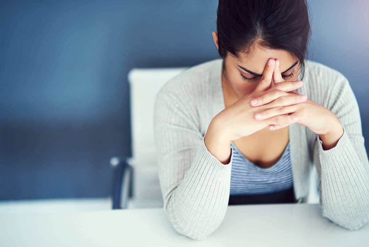 Desk, tired and businesswoman with stress, burnout and anxiety for overthinking as content writer. Exhausted, female journalist and deadline crisis of political article, copywriting or blog in office
