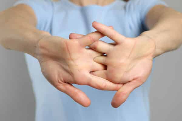 Woman cracking her knuckles