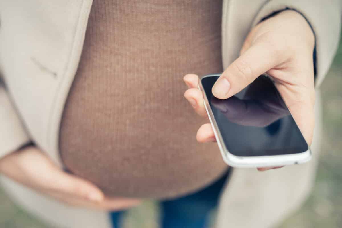 Pregnant woman using her smartphone