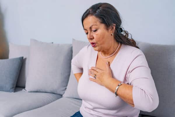 Older woman having chest pains or a heart attack